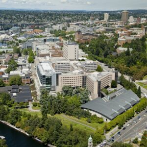 Aerial photo of the UW Seattle Campus, featuring intersecting streets, buildings, bridges, and landscape architecture of campus by Drumheller Fountain